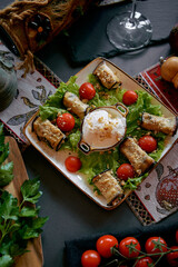 Delicious Plate of Stuffed Eggplant Rolls Served with Creamy Yogurt and Fresh Cherry Tomatoes on a Bed of Crisp Lettuce for a Vibrant Culinary Experience