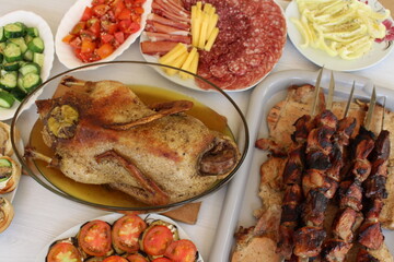 barbecue, roast duck and various light appetizers with vegetables