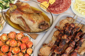 barbecue, roast duck and various light appetizers with vegetables