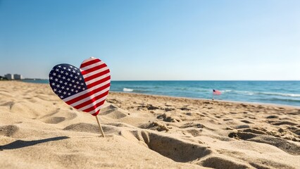 Heart shaped American flag on sandy beach under blue sky patriotic summer vacation