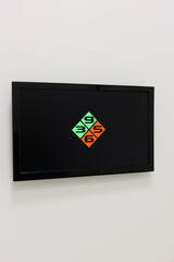 Digital optometry screen showing a black background with a diamond pattern of green and orange squares displaying the numbers 3, 5, 6, and 9 for vision testing