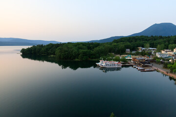 Fototapeta premium Tranquil Lakeside View of Lake Akan with Mount Oakan in Hokkaido, Japan