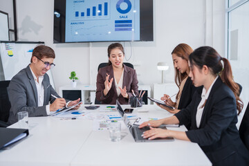 Group of Asian business people meeting and presenting work in the office