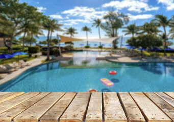 Wooden table top on the beach or sea. swimming pool Party on the beach  sunshine time concept.For montage product display or design key visual layout.View of copy space.