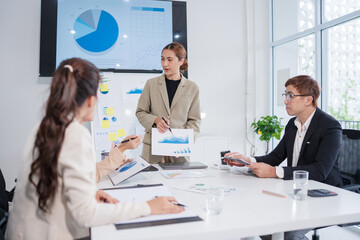 Group of Asian business people meeting and presenting work in the office