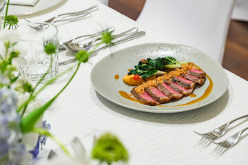 pack of sliced beef steak in dish with appetized vegetable