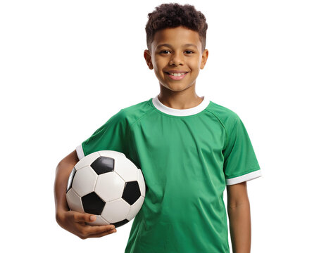 A young boy in a green soccer jersey is smiling and holding a black and white soccer