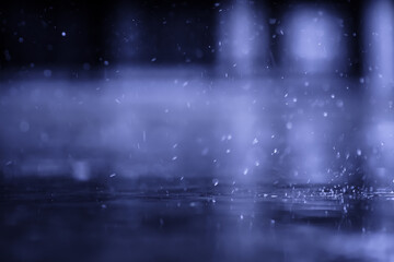 raining on the concrete walk way full with rain droplets splash ring bounce off the surface of water with reflected of white cloudy sky