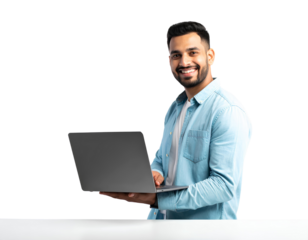 An attractive Indian man smiling and using a laptop on a white table, isolated on transparent background.