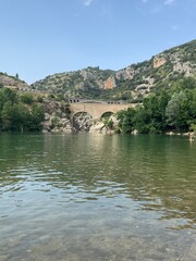 Evil bridge reflecting on the water surface of the H&eacute;rault river