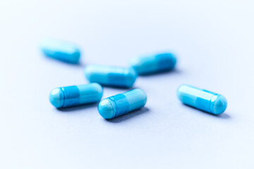 Amino acids capsules on bright background. Soft focus. Close up. Copy space.	