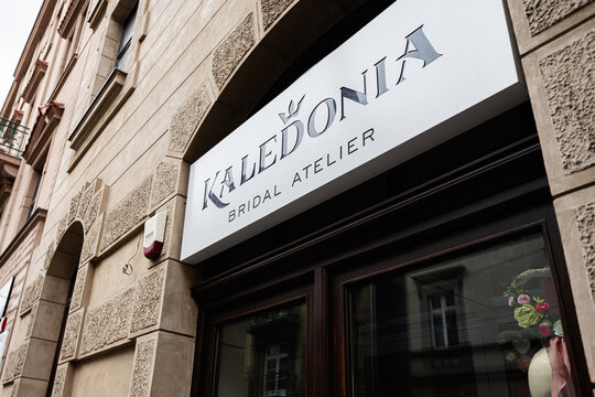 Elegant bridal atelier Kaledonia entrance on a sunlit street in Krakow, Poland