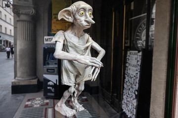 Fototapeta premium Statue of Dobby from Harry Potter mythical creature displayed in Krakow, Poland city street view