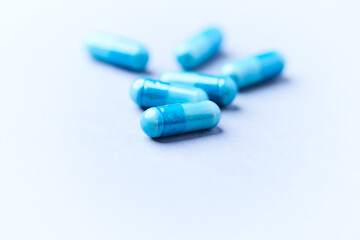 Amino acids capsules on bright background. Soft focus. Close up. Copy space.	