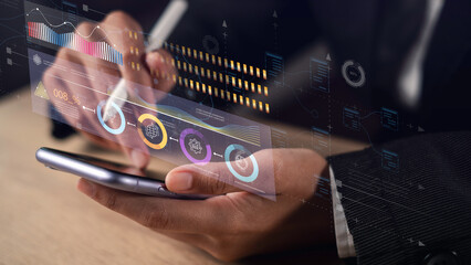 Businessman using smartphone and digital pen analyzing futuristic data interface, representing AI-driven business growth strategy and intelligent business planning for future success.