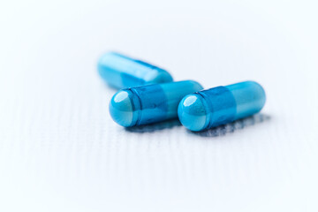 Amino acids capsules on bright background. Soft focus. Close up. Copy space.	