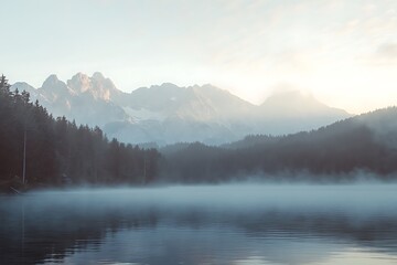 Misty morning serenity snow capped peaks reflecting in a calm lake amidst forested hills