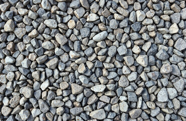 Gray gravel stones in various sizes covering the ground  