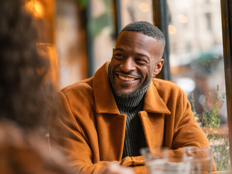 Smiling African American Man Enjoying Coffee in Cozy Café Setting | Warm Hospitality and Relaxed Atmosphere