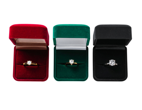  Three Velvet Proposal Boxes with Different Diamond Rings, Flat Lay Arrangement, Isolated