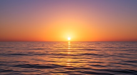 Obraz premium The sun hangs low on the horizon, casting a fiery glow over the calm ocean and creating a shimmering, golden path of light on the water's surface.