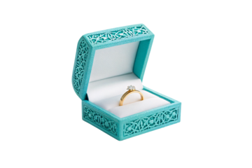 Open decorative teal ring box displaying gold engagement ring with sparkling diamond solitaire setting, isolated on a transparent background