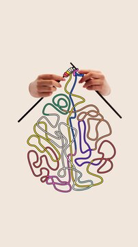 Playful stop motion. Ideas in progress. Hands knit colorful tangled threads into brain, showing how bright thoughts form gradually from inner chaos. Concept of creativity, design, imagination