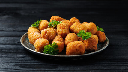 Deep fried potato croquettes with ham in a plate