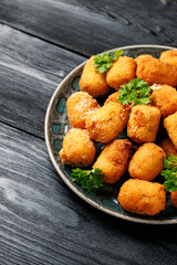 Deep fried potato croquettes with ham in a plate