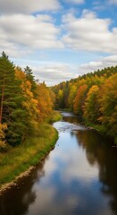 Autumnal river winds through colorful woods.