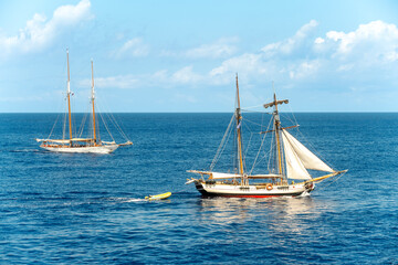 Two sailing boats sailing in the open sea