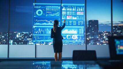 Businesswoman analyzing data on futuristic interactive displays - Powered by Adobe