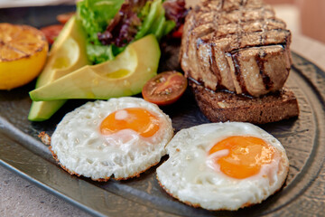 A Delightful Gourmet Plate Featuring Grilled Chicken, Fresh Greens, Avocado, and Eggs Prepared to Perfection for a Nutritious Meal Experience