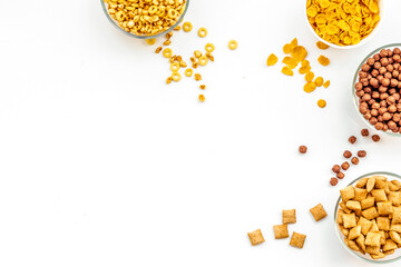 Various cereals in bowls on white background top view copyspace