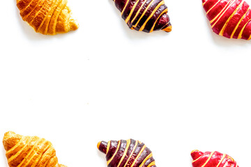 Frame of croissants - fresh bakery on white background. Top view