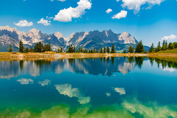 Alpine summer view with reflections in a lake and Mount Wilder Kaiser at Mount Astberg, Going,...