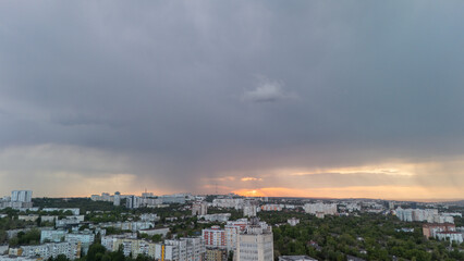 Aerial city view with storm clouds and light streaks