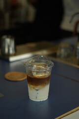 Closeup of Iced Caramel Macchiato at the coffee shop, Caramel Macchiato is a classic macchiato beverage. It consists of vanilla syrup, espresso, steamed milk, foam, and caramel drizzle