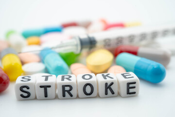 Stroke word with pills and capsules medical drug.