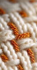 Close-up of knitted fabric with orange accents
