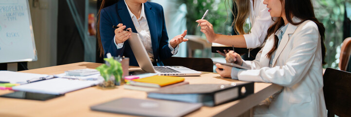 Mentor coaching new office trainee under supervision of senior employee in company workplace...