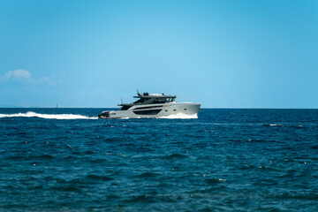 A small yacht sailing on the open sea