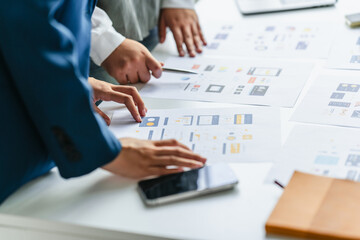 UI designer and UX specialist collaborating on digital prototypes in brainstorm