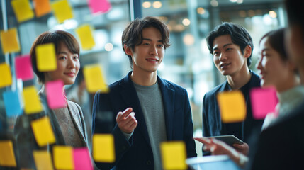 Young professionals brainstorming with sticky notes in modern office