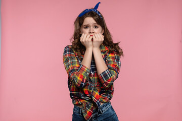 Worried Young Woman with Colorful Plaid Shirt on Pink Background