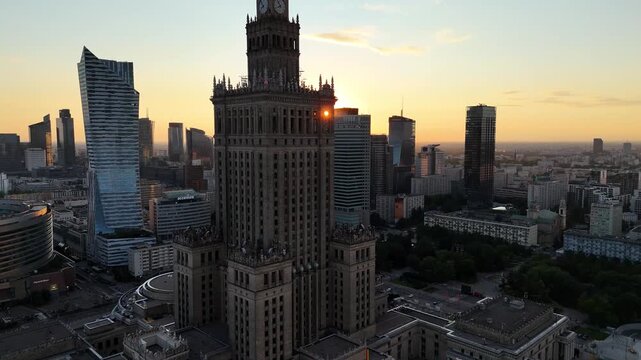 Aerial drone flight past the Palace of Culture and Science in Warsaw at sunset, Poland, 4K
