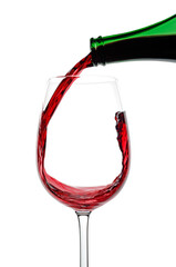 Red Wine being poured into a glass against a white background, close up