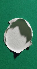 Ripped circle of white paper on green background