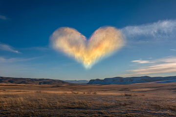 a heart shaped cloud is in the sky
