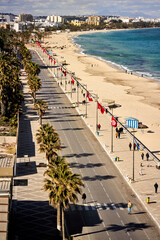 Tourists walking on the promenade of sousse in tunisia